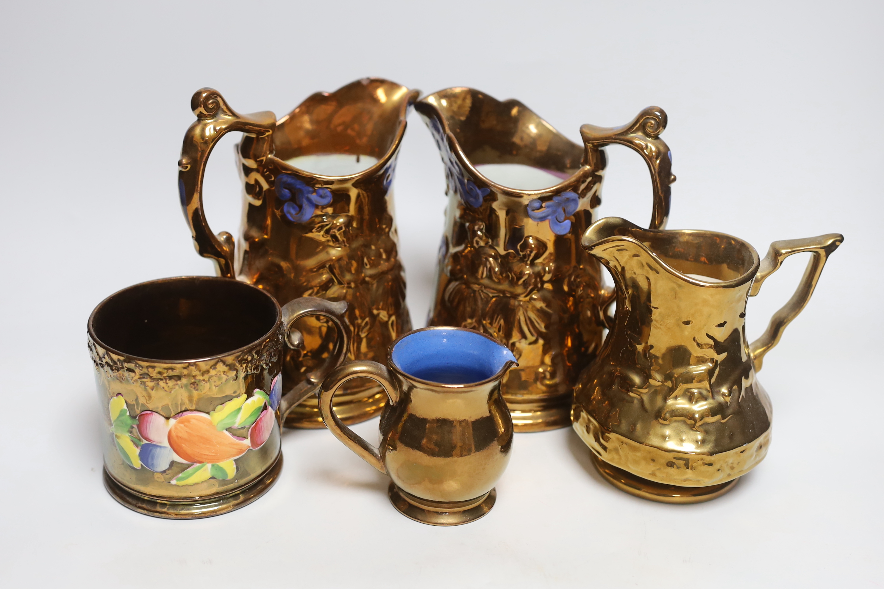 Four Victorian copper lustre jugs and a mug, tallest 21cm (4)